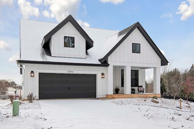 modern inspired farmhouse featuring covered porch and a garage