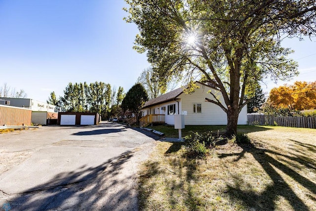 exterior space featuring a yard, a garage, and an outdoor structure