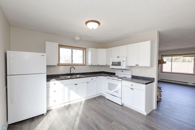 kitchen featuring white cabinetry, sink, a baseboard heating unit, white appliances, and wood-type flooring