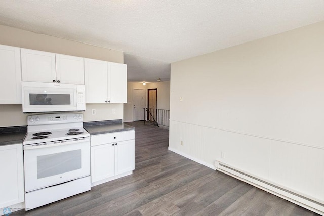 kitchen featuring dark wood finished floors, dark countertops, white appliances, a baseboard radiator, and white cabinetry