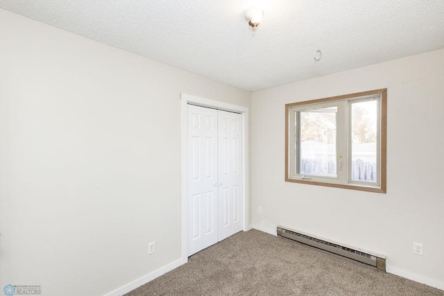 unfurnished bedroom featuring light carpet, a baseboard radiator, and a textured ceiling