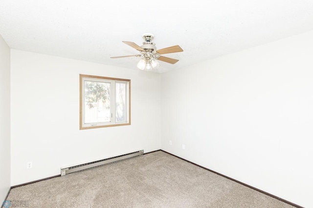 carpeted empty room with a baseboard heating unit, baseboards, and a ceiling fan
