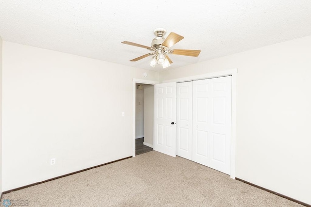 unfurnished bedroom with a closet, carpet flooring, baseboards, and a ceiling fan
