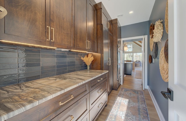 6620 Buckthorn Dr NW, Rochester, MN 55901 - kitchen with backsplash, baseboards, light wood-style floors, dark brown cabinets, and recessed lighting