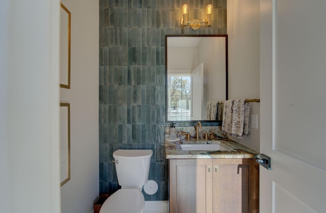 6620 Buckthorn Dr NW, Rochester, MN 55901 - half bathroom with vanity, tile walls, and toilet