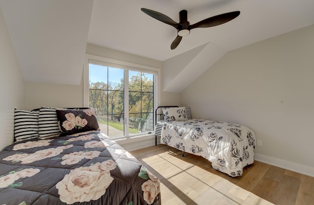 6620 Buckthorn Dr NW, Rochester, MN 55901 - bedroom featuring wood finished floors, a ceiling fan, vaulted ceiling, and baseboards