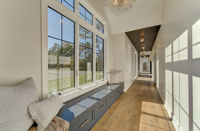 6620 Buckthorn Dr NW, Rochester, MN 55901 - hallway featuring light wood-type flooring, healthy amount of natural light, a chandelier, a towering ceiling, and baseboards