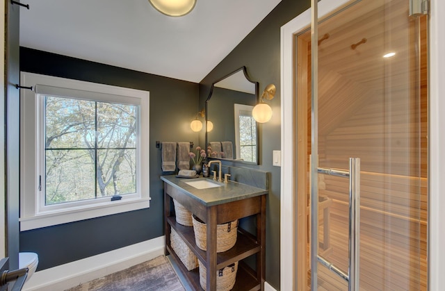 6620 Buckthorn Dr NW, Rochester, MN 55901 - bathroom with vaulted ceiling, toilet, vanity, and baseboards