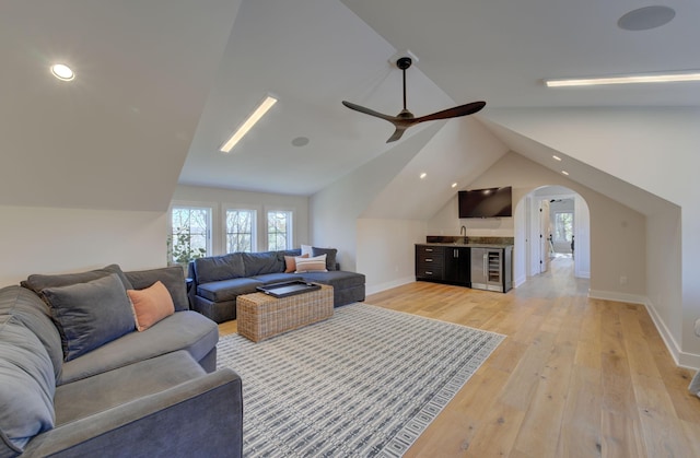 6620 Buckthorn Dr NW, Rochester, MN 55901 - living area featuring vaulted ceiling, ceiling fan, light wood-type flooring, recessed lighting, and arched walkways