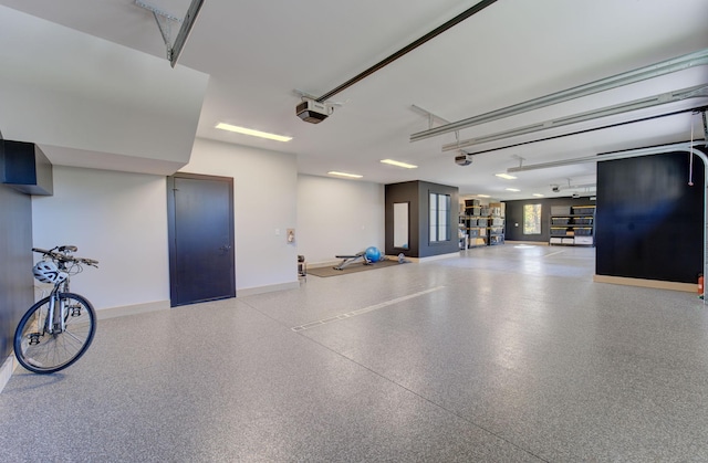 6620 Buckthorn Dr NW, Rochester, MN 55901 - garage featuring baseboards and a garage door opener