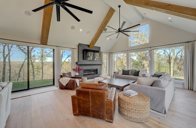 6620 Buckthorn Dr NW, Rochester, MN 55901 - living area featuring ceiling fan, high vaulted ceiling, beamed ceiling, a fireplace, and healthy amount of natural light