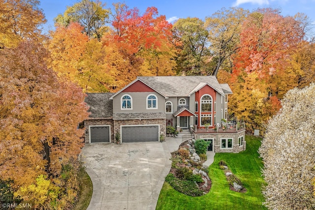 view of front of property with a front lawn and a garage