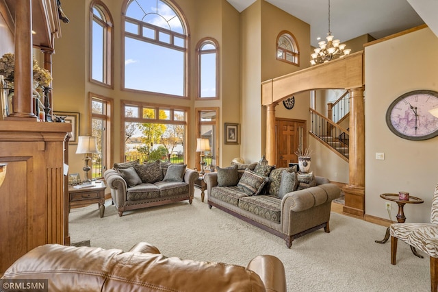 living room featuring a towering ceiling, an inviting chandelier, and carpet