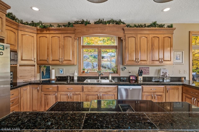 kitchen featuring sink, appliances with stainless steel finishes, and a textured ceiling