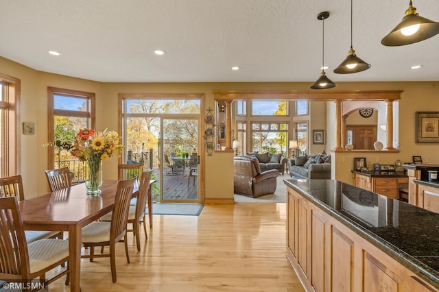 dining room with a textured ceiling and light wood-type flooring