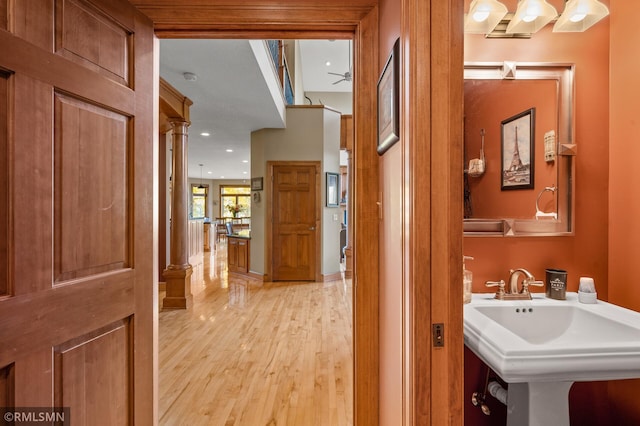 bathroom featuring ceiling fan, wood-type flooring, and sink