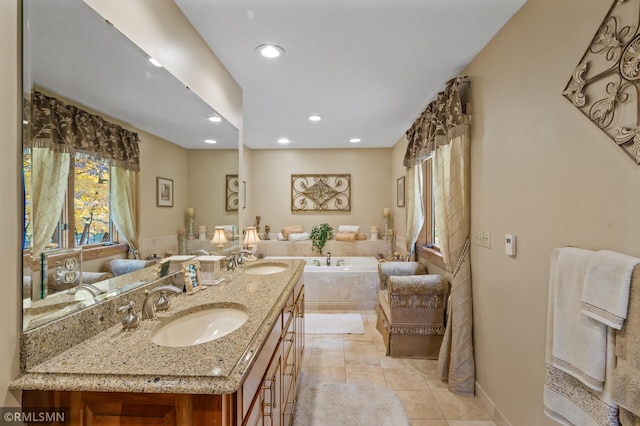 bathroom with vanity, a relaxing tiled tub, and tile patterned floors