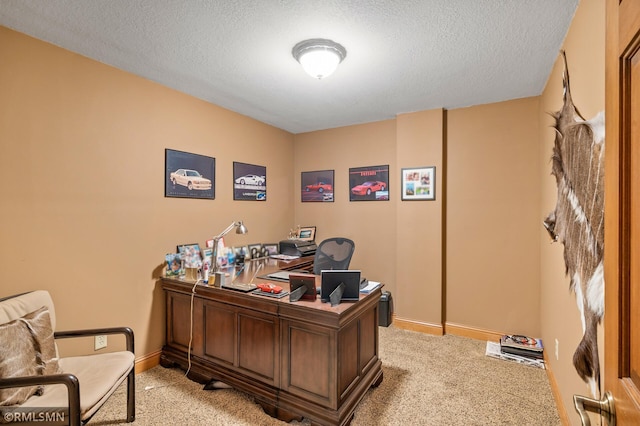 home office featuring light carpet and a textured ceiling