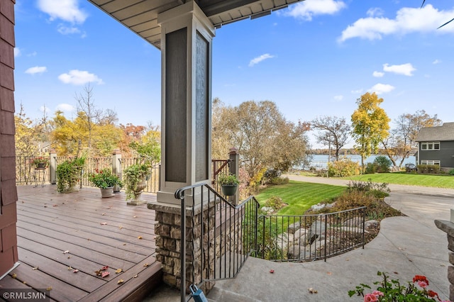 wooden terrace featuring a lawn