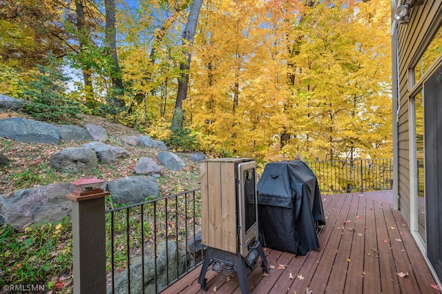 wooden deck featuring a grill