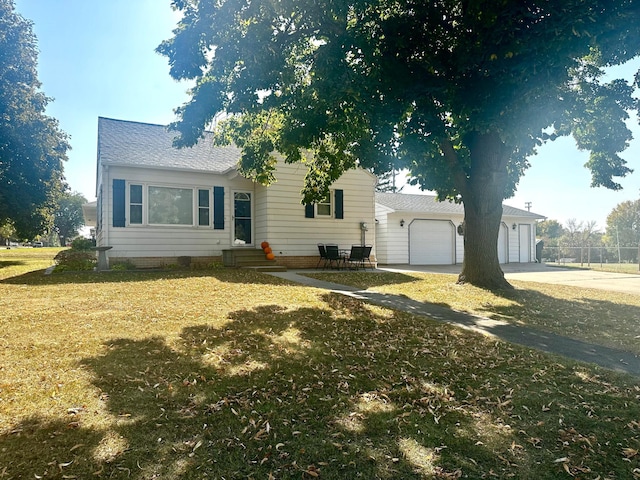 single story home with a front yard and a garage