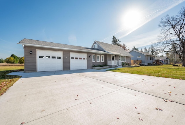 view of front of home featuring a front yard and a garage