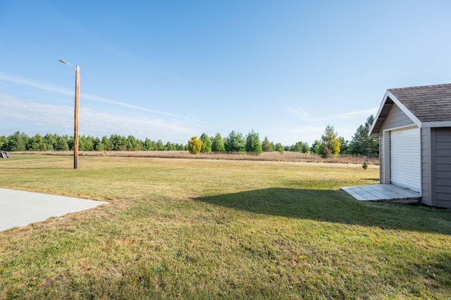 view of yard with an outdoor structure and a rural view