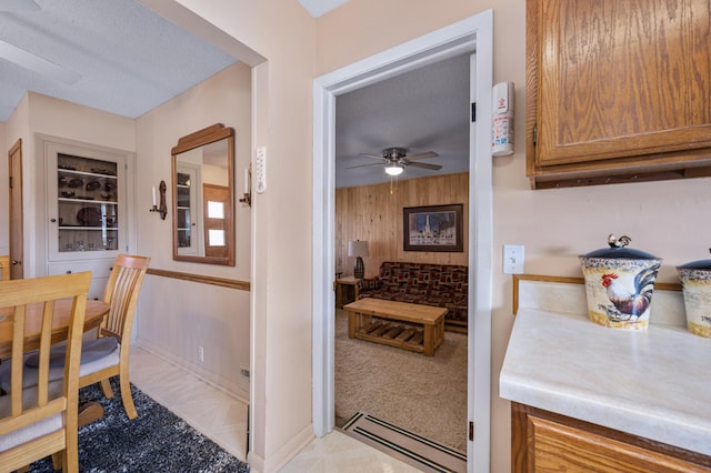 kitchen featuring ceiling fan, light carpet, a textured ceiling, and baseboard heating