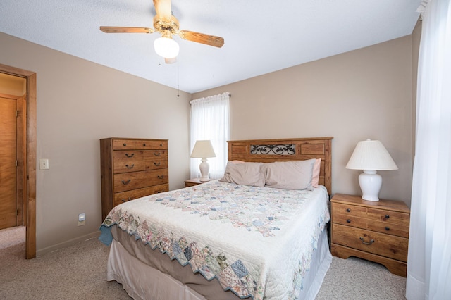 bedroom with light colored carpet and ceiling fan