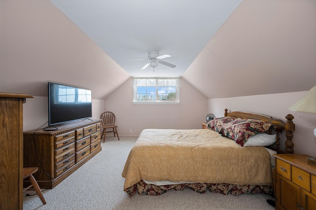 carpeted bedroom with multiple windows, vaulted ceiling, and ceiling fan