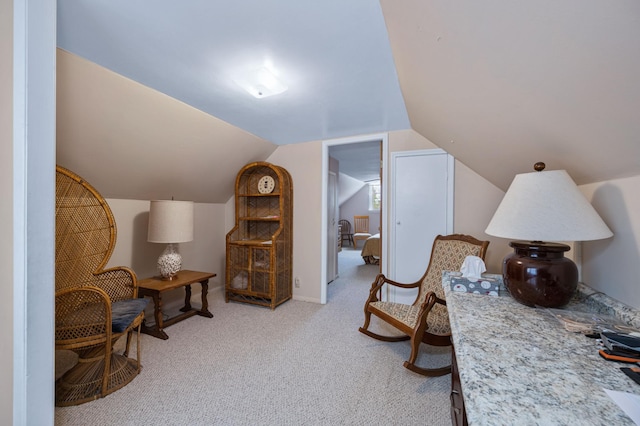 living area featuring lofted ceiling and light colored carpet