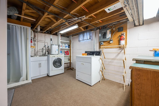 laundry area with electric panel, light carpet, separate washer and dryer, and cabinets