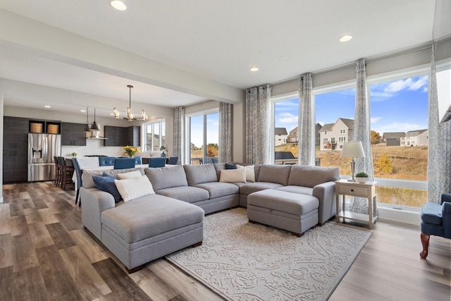 living room featuring a notable chandelier and wood-type flooring