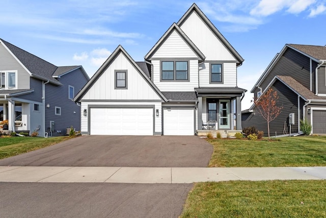 view of front of home with a garage and a front lawn