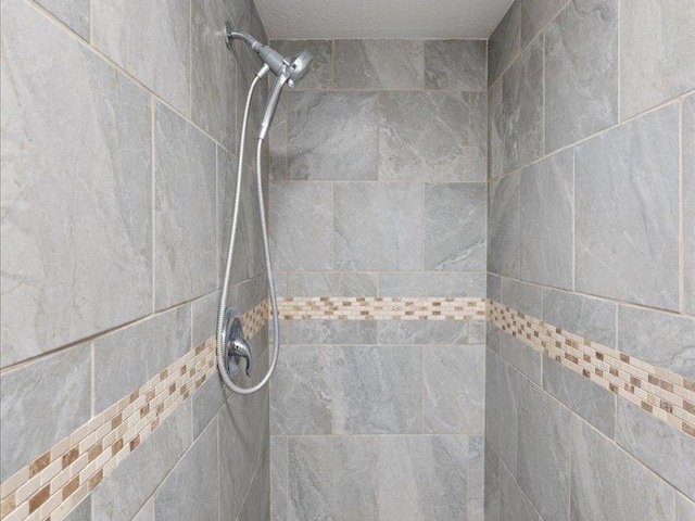 bathroom with a tile shower