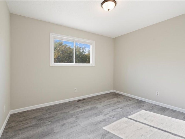 unfurnished room featuring light hardwood / wood-style flooring