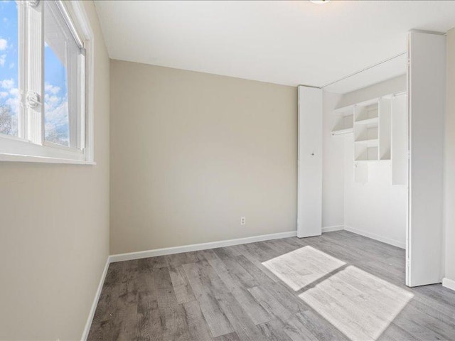 empty room with light hardwood / wood-style flooring