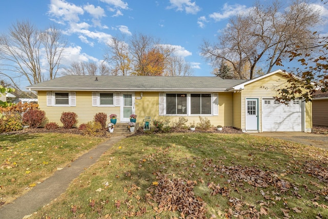 ranch-style home with an attached garage, driveway, and a front yard