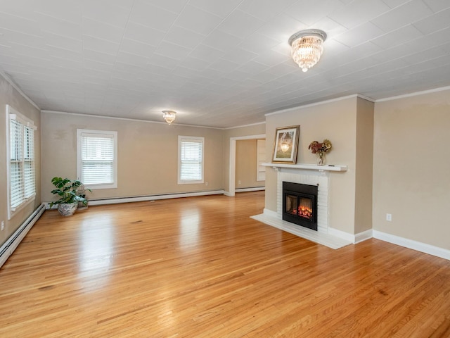 unfurnished living room featuring a notable chandelier, a baseboard radiator, light wood-type flooring, a brick fireplace, and crown molding