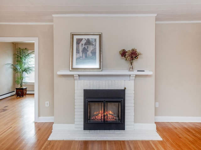 room details featuring crown molding, wood-type flooring, a baseboard radiator, and a brick fireplace