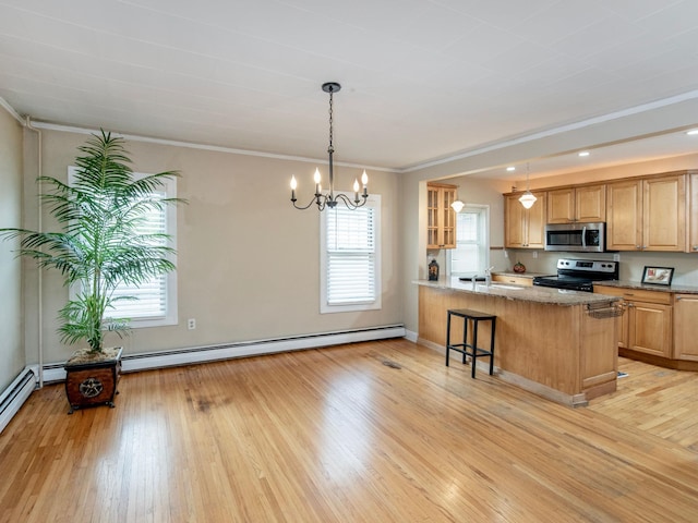 kitchen with a breakfast bar area, kitchen peninsula, stainless steel appliances, and a wealth of natural light