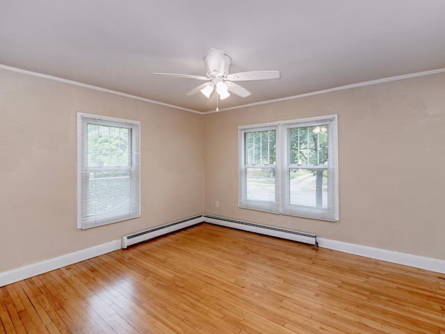 spare room with light hardwood / wood-style floors, ornamental molding, a baseboard heating unit, and ceiling fan