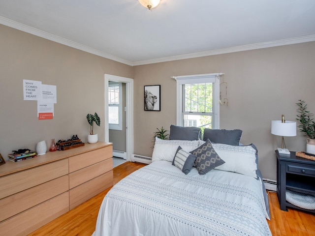 bedroom with ornamental molding, multiple windows, and hardwood / wood-style floors