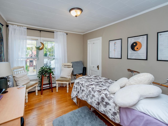 bedroom with crown molding and hardwood / wood-style floors