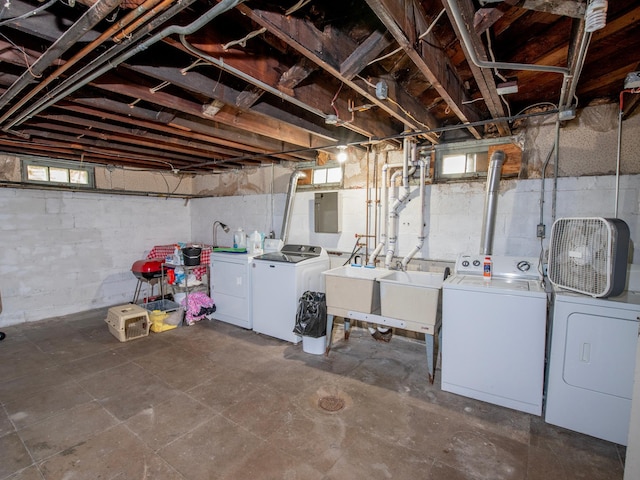 basement with sink and washing machine and dryer