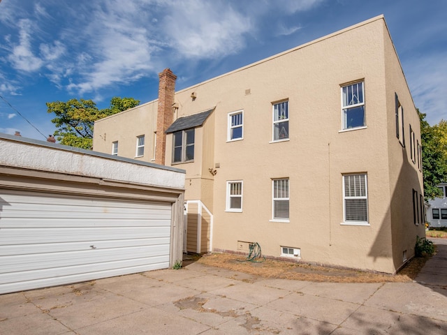 rear view of house featuring a garage