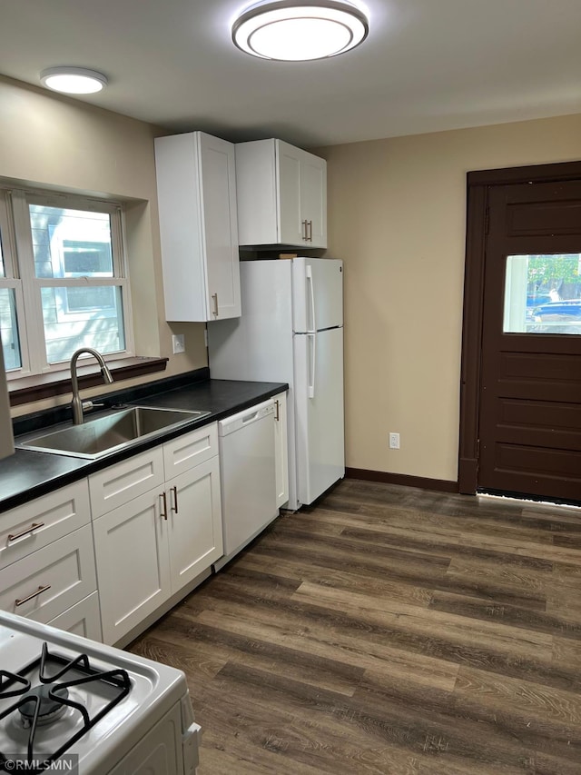 kitchen featuring dark hardwood / wood-style flooring, white appliances, white cabinetry, and sink