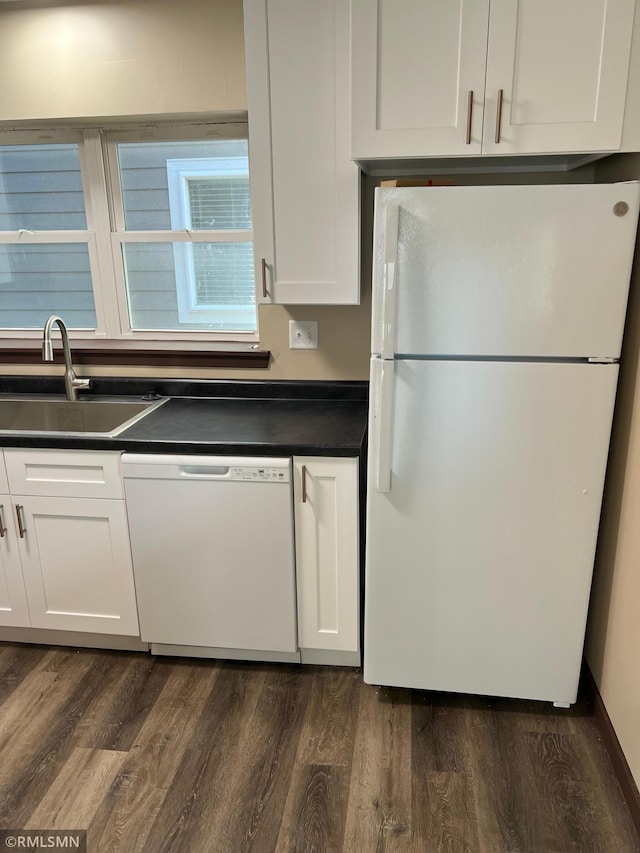 kitchen with white cabinets, white appliances, dark wood-type flooring, and sink