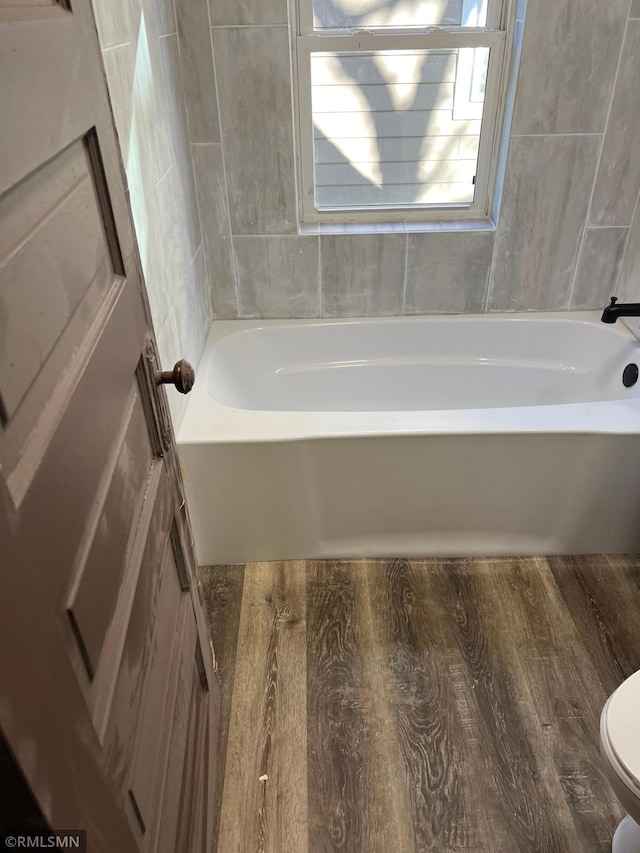 bathroom featuring hardwood / wood-style floors and toilet