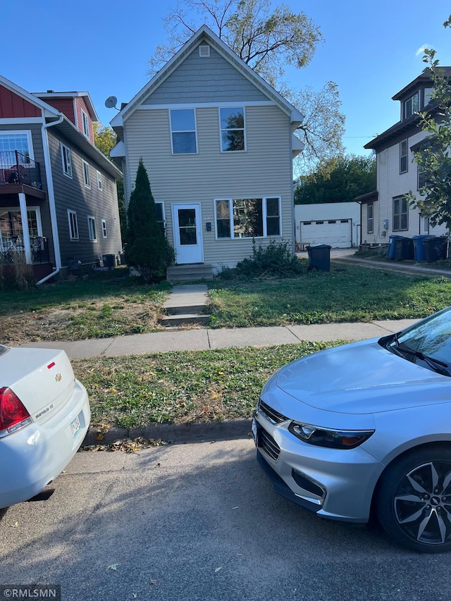 front facade featuring an outbuilding and a garage